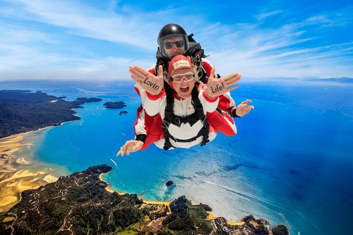 a man flying through the air over a body of water