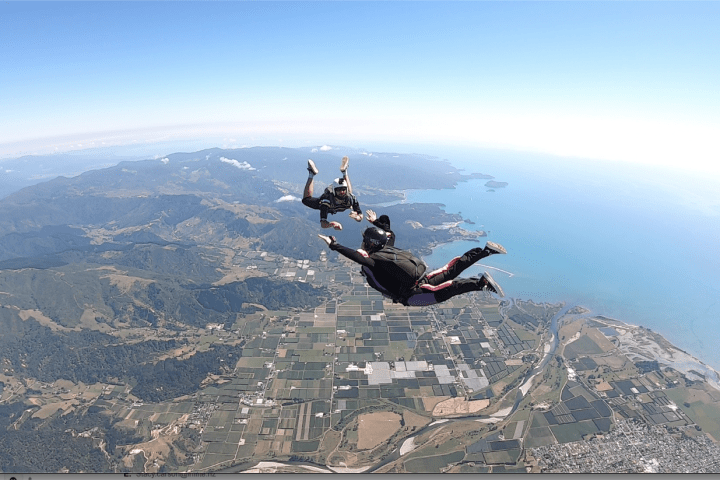 a man flying through the air on a mountain