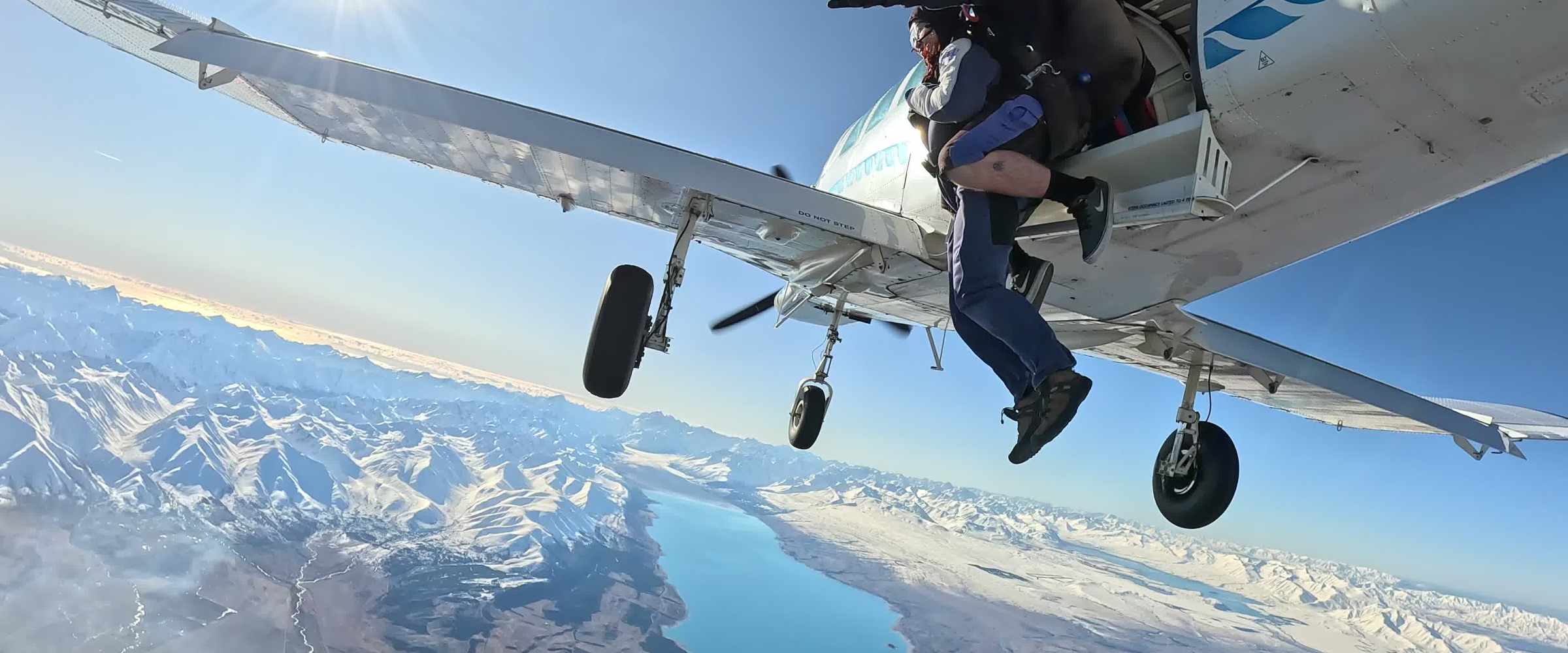 a man flying through the air on a snow covered mountain