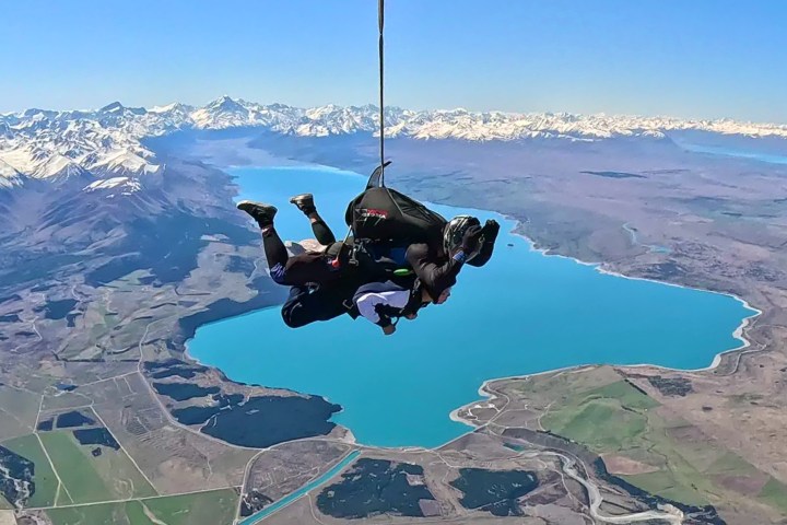 a person flying through the air on top of a mountain